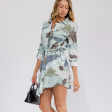 Woman wearing a camouflage dress on a white background