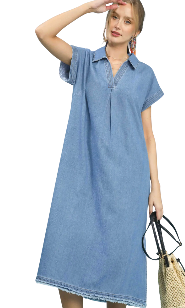 Woman wearing a blue denim dress on a white background