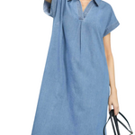 Woman wearing a blue denim dress on a white background