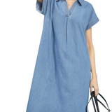 Woman wearing a blue denim dress on a white background