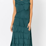 Woman wearing a teal ruffled dress on a white background