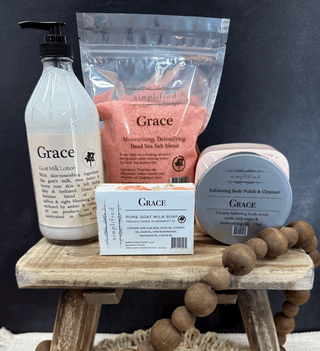 Collection of 'Grace' skincare products on a wooden stand with a dark background