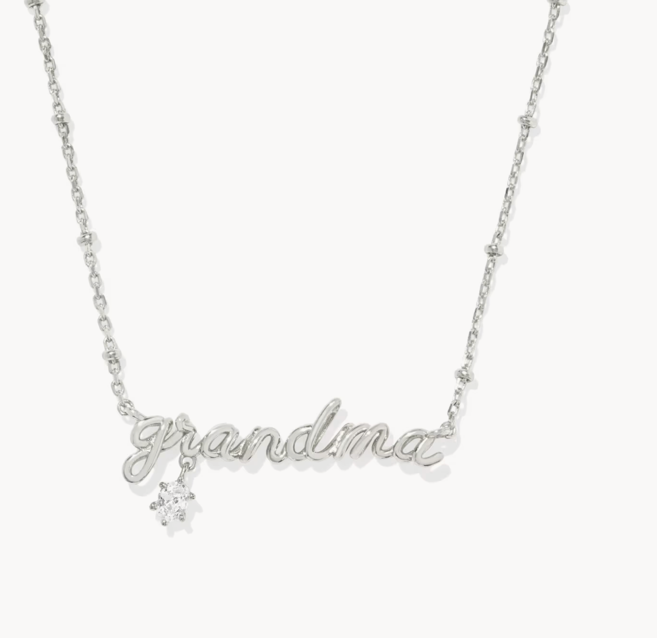 Silver necklace with 'grandma' and a snowflake charm on a white background
