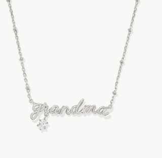 Silver necklace with 'grandma' and a snowflake charm on a white background