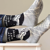 Gray socks with black and white designs on a white chair