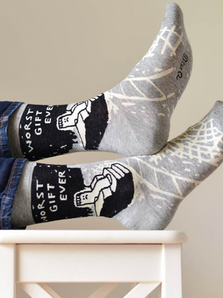 Gray socks with black and white designs on a white chair