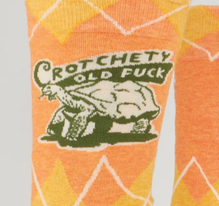 Socks with a graphic design featuring text and a bear on an orange background.