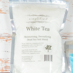 White tea packaging on a wooden surface