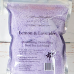 Purple Dead Sea salt blend packaging with 'simplified' branding on a wooden surface