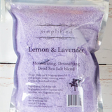 Purple Dead Sea salt blend packaging with 'simplified' branding on a wooden surface