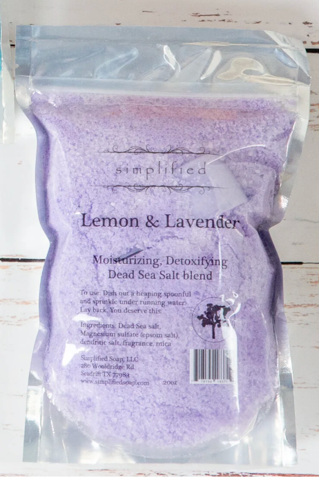Purple Dead Sea salt blend packaging with 'simplified' branding on a wooden surface