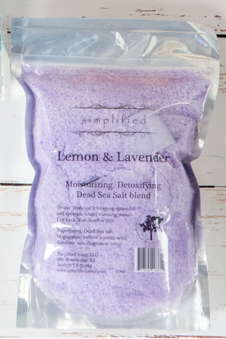 Purple Dead Sea salt blend packaging with 'simplified' branding on a wooden surface