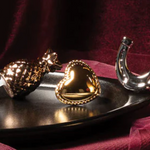GOLD FIGURINES ON A BLACK TRAY