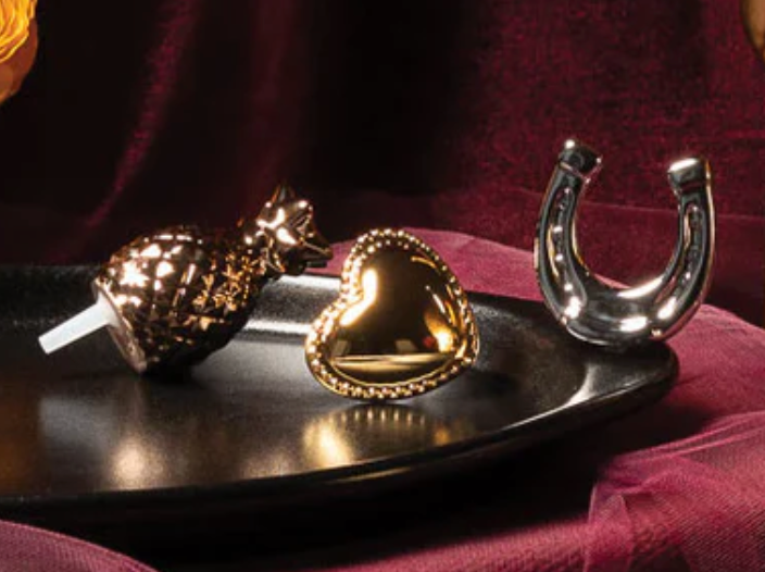 GOLD FIGURINES ON A BLACK TRAY