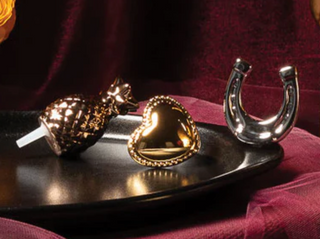 GOLD FIGURINES ON A BLACK TRAY