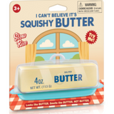 A novelty butter product in retail packaging. The package shows a pale yellow butter-like stick labeled 'BUTTER' and '4 oz.