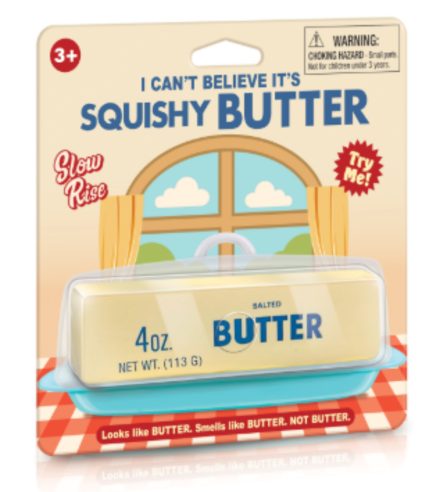A novelty butter product in retail packaging. The package shows a pale yellow butter-like stick labeled 'BUTTER' and '4 oz.