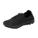 A black slip-on woven shoe with a textured knit upper, black laces, and a chunky black sole, shown from a three-quarters angle on a white background.