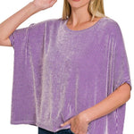 Woman wearing a purple and white striped shirt on a white background