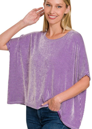 Woman wearing a purple and white striped shirt on a white background