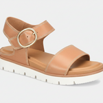 Tan sandal with a gold buckle on a white background