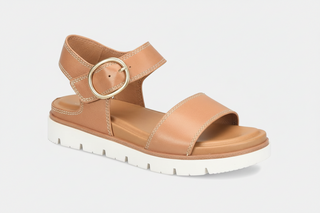 Tan sandal with a gold buckle on a white background