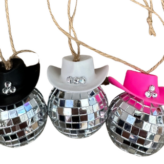 Three disco ball ornaments with cowboy hats in black, silver, and pink on a white background.