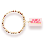 Gold beaded hair tie with 'Beaded Blondes' packaging on a white background
