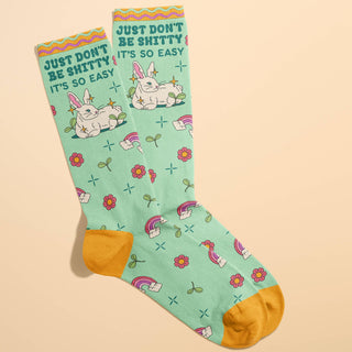 Pair of socks with cartoon characters and text on a beige background