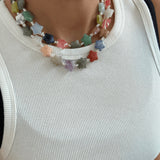 Colorful beaded necklace with star-shaped beads on a white background