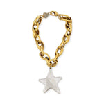 Gold chain bracelet with a silver star charm on a white background