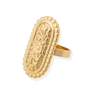 Gold ring with intricate floral design on a white background