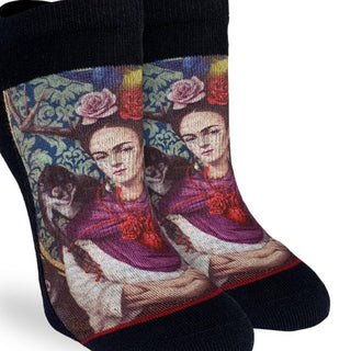 Pair of socks with a design of a woman with flowers in her hair and a dog on a white background