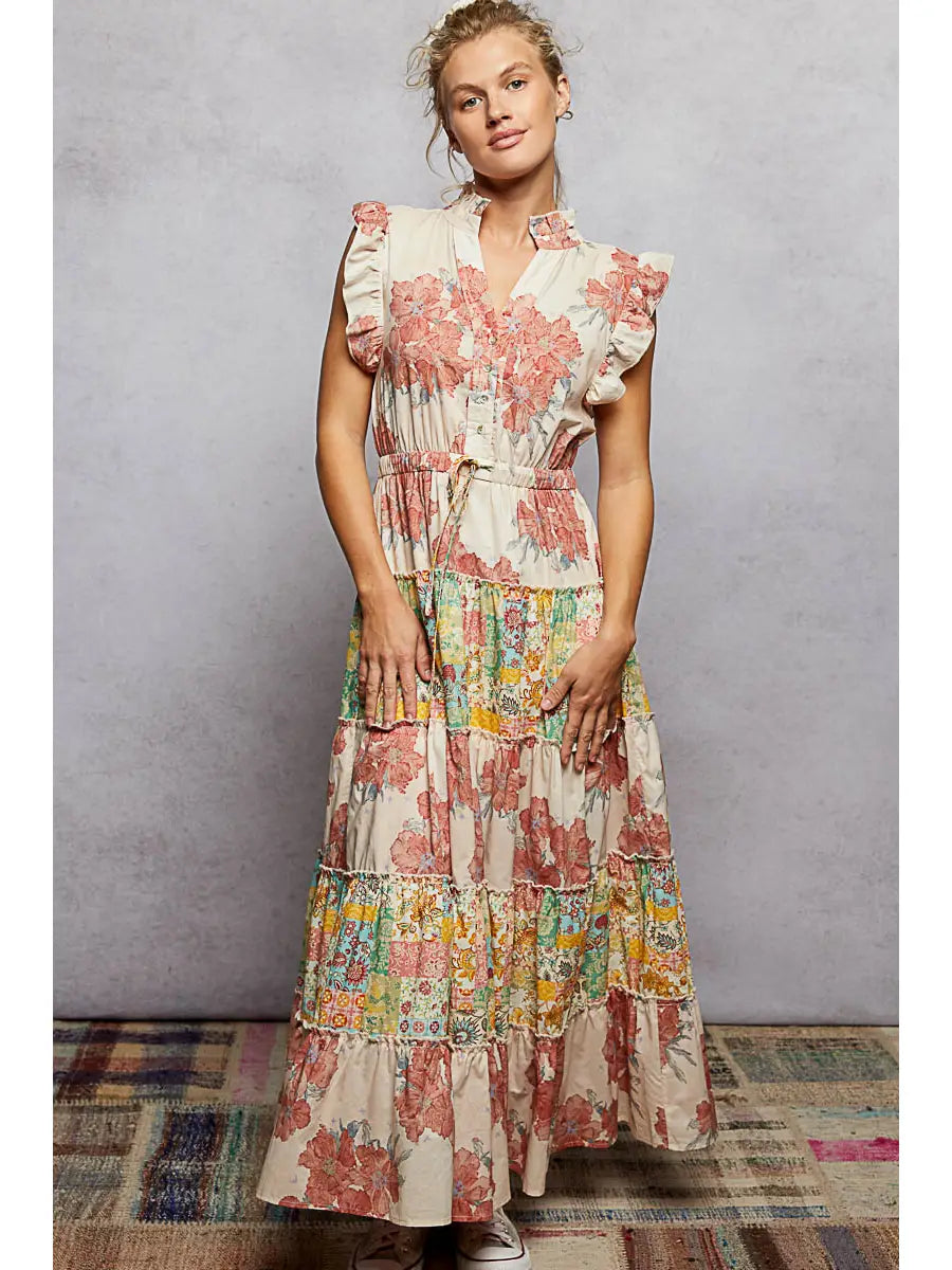 Woman wearing a floral dress against a plain background