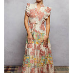 Woman wearing a floral dress against a plain background