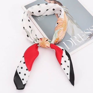 Decorative scarf with polka dot and floral patterns on a magazine cover.