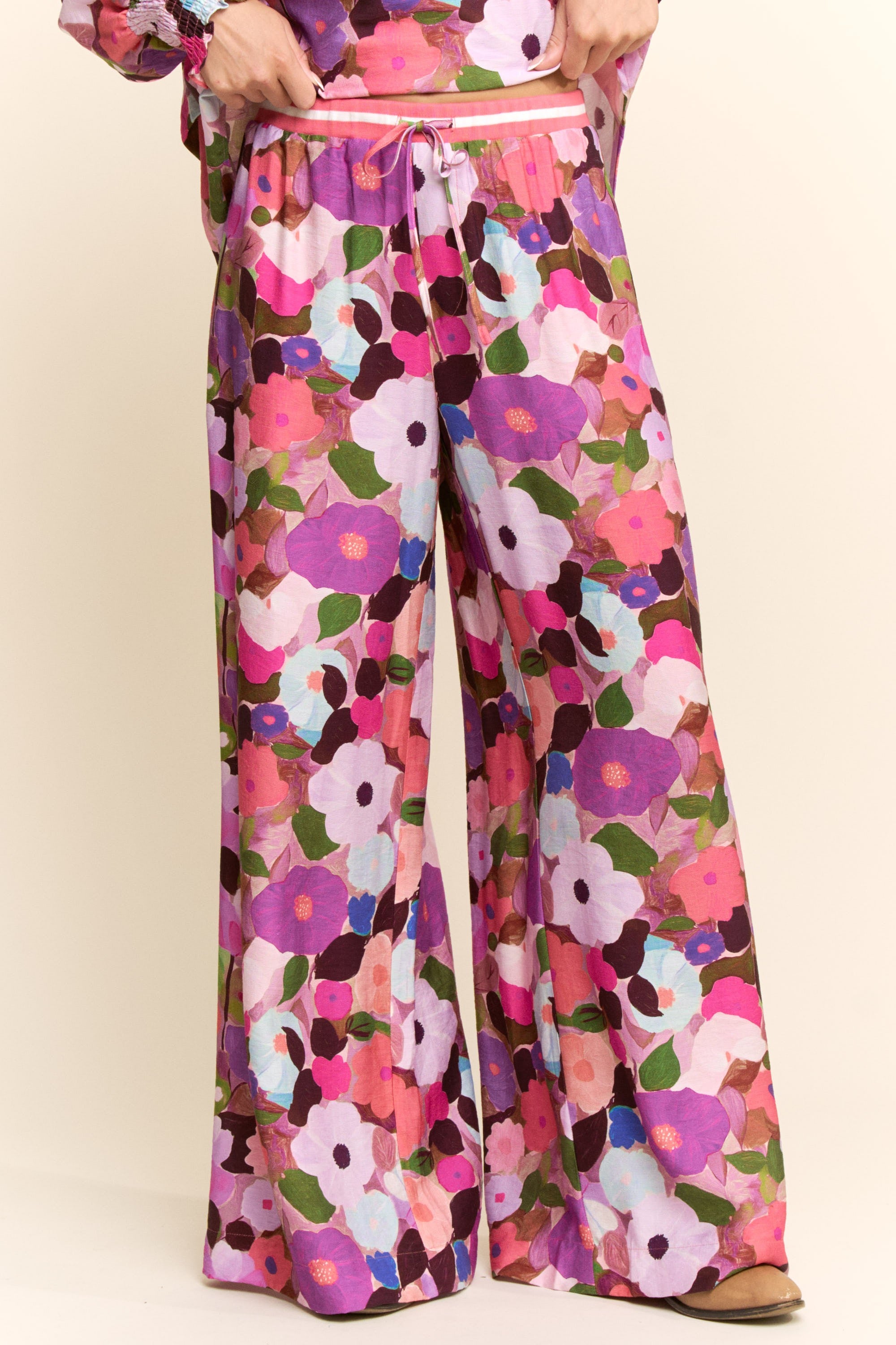 Floral patterned pants with a colorful design on a plain background
