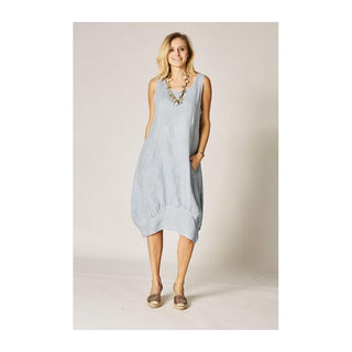 Woman wearing a light blue dress against a plain background