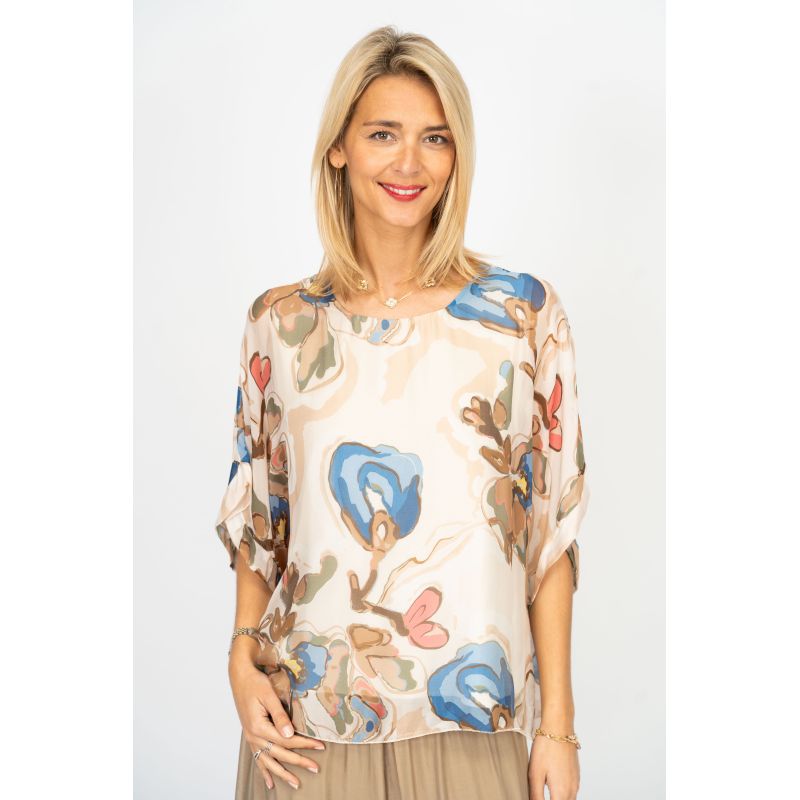 Woman wearing a floral blouse with a plain background