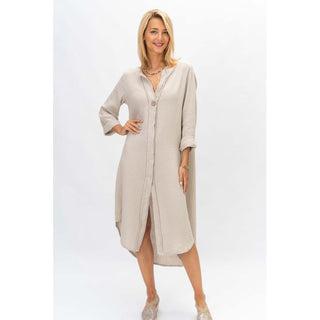 Woman wearing a beige long dress on a white background