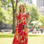 Blonde model wearing geo print midi dress in park with children