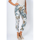 Floral patterned pants worn by a person on a white background