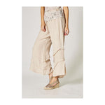 Beige wide-leg pants worn by a person on a plain background