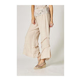 Beige wide-leg pants worn by a person on a plain background