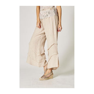 Beige wide-leg pants worn by a person on a plain background