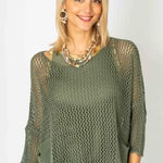 Woman wearing a green knit top and skirt set against a white background