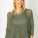 Woman wearing a green knit top and skirt set against a white background