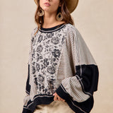 Woman wearing a patterned sweater with a neutral background