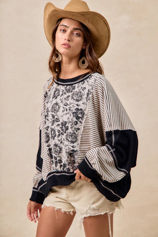 Woman wearing a patterned sweater with a neutral background
