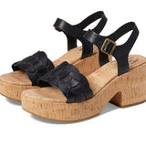Black strappy sandals with cork platforms on a white background